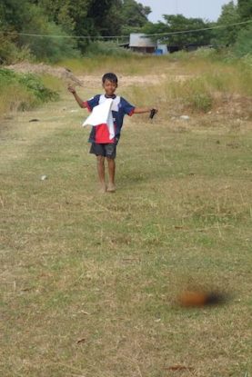 Un enfant joue au cerf volant du coté de Kep. Article complet sur le blog https://yoytourdumonde.fr